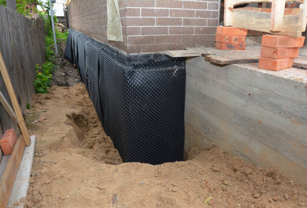 Happy homeowners after waterproofing job in Etna Green